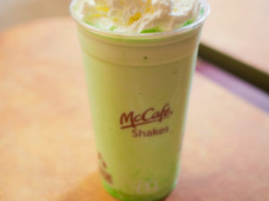 The green Shamrock McCafe Shake topped with whipped cream and a cherry